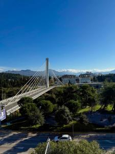 a bridge in a city with cars parked at Milenijum apartman in Podgorica