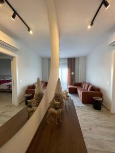 a living room with figurines of animals on a wall at Class Elite Apartment in Shkodër