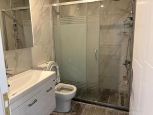 a bathroom with a shower and a toilet and a sink at Veray Homes, Alsancak in Ayios Dhometios +10 photos