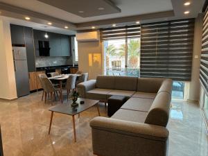 a living room with a couch and a table at Veray Homes, Alsancak in Ayios Dhometios