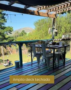 an outdoor deck with a table and chairs at Amanda Relax and nature beautiful beach in Playa Hermosa