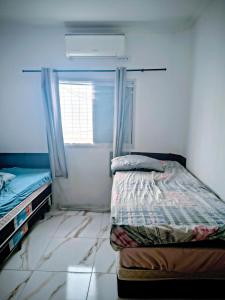 Ένα ή περισσότερα κρεβάτια σε δωμάτιο στο Condomínio Residencial Marbelle