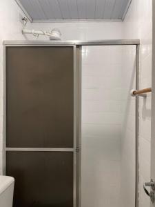 Casa Confortável e Prática de 1 Quarto acomoda até 5 pessoas في فوز دو إيغواسو: دش مع باب زجاجي في الحمام