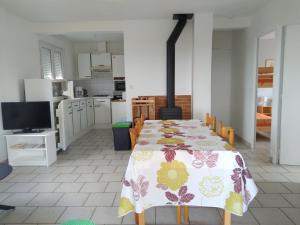 a kitchen with a table with a flower pattern on it at Gîte Acacia in Rosières