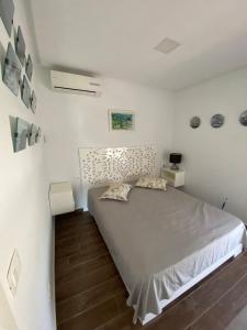 a bedroom with a large bed in a white room at Duplex Rim ,with swimming pool in Ḩammām al Ghazzāz +38 photos
