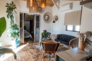 a living room with a blue couch and a table at Cottage, Lodge & Spa 54 in Prouilly
