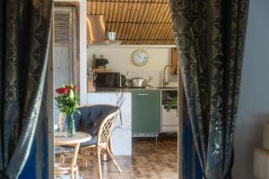 a small kitchen with a table and a table and chairs at Cottage, Lodge & Spa 54 in Prouilly +7 photos