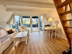 a living room with a couch and a table at M398-Gedser-Gedser-Feriepark-32 in Gedser +10 photos