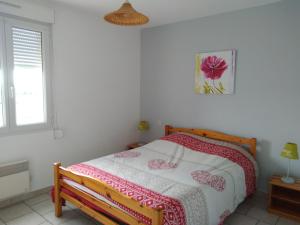 a bedroom with a bed and a window at Gîte Acacia in Rosières +3 photos