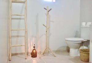 a bathroom with two wooden crosses and a toilet at Camp Ayour Mhamid in Mhamid +64 photos