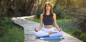 a woman sitting in a yoga pose on a path at Aguas Arriba Lodge in El Chalten