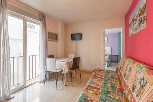 a bedroom with a bed and a table with chairs at Duque Center Premium Suites in Seville