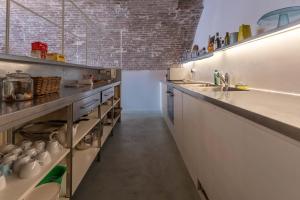 a large kitchen with a counter and a sink at Villa Le Contrade - Rifugio nel Borgo Storico in Santarcangelo di Romagna +15 photos