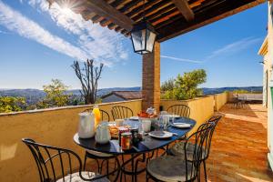 a table and chairs on a balcony with a view at Villa Miradou in Saint Paul de Vence