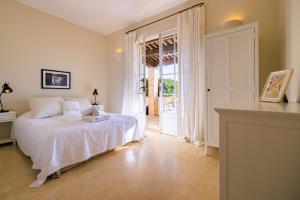 a bedroom with a bed and a door to a patio at Villa Miradou in Saint Paul de Vence +22 photos