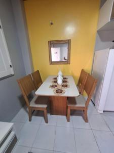 ein Esszimmer mit Tisch und Stühlen und einem Spiegel in der Unterkunft Chalé Descanso - Cond Porto dos lençois Barreirinhas in Barreirinhas