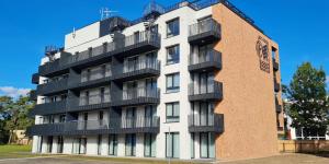 a building with balconies on the side of it at Central Park Mielno Operator Team- apartament IVO in Mielno
