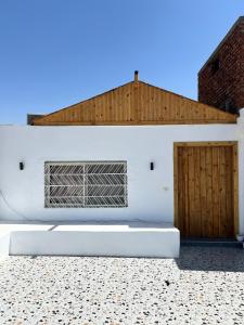 a white building with a window and a door at Hathors Terrace Apartment in Luxor