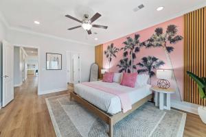 a bedroom with a bed with palm trees on the wall at Bright Waves Fort Morgan in Gulf Shores +46 photos