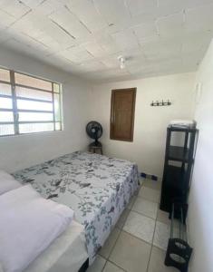 Ένα ή περισσότερα κρεβάτια σε δωμάτιο στο Casa em Itamaracá