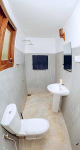 a bathroom with a toilet and a sink at Stay Salty in Matara