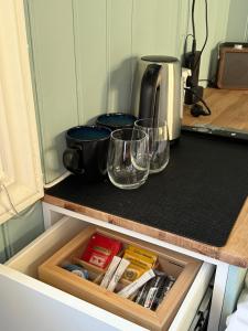 a kitchen counter with two glasses and a coffee maker at Anekset in Sandefjord