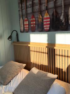 a bedroom with a bed and a shelf with vases at Anekset in Sandefjord