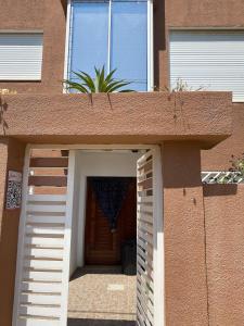 a building with a door with a plant in it at Rim Apartment , Beachfront in Ḩammām al Ghazzāz