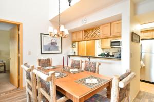 a kitchen and dining room with a wooden table and chairs at Lake Forest Summit Condo: Great Penthouse Views in Summit Medical Center Heliport