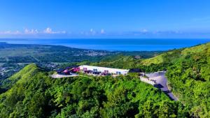 a building on a hill with the ocean in the background at The View Luxe Boutique Hotel 