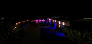 a night view of a building with purple lights at The View Luxe Boutique Hotel  +1 photo