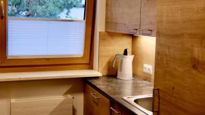 a small kitchen with a sink and a window at Kurapotheke in Bad Hofgastein