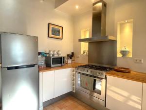 Saint-Benoist-sur-MerLa Parenthèse à la Mer - Swimming Pool - Family的配有不锈钢冰箱和白色橱柜的厨房