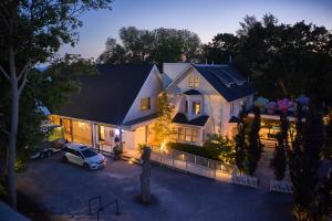 an aerial view of a house with a car in a driveway at Drake Devonshire and Motor Inn in Wellington