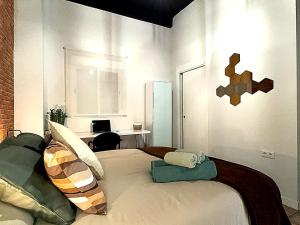 a bedroom with a bed with pillows on it at Apartmento Ópalo in Seville