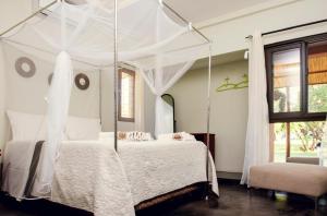 Ένα ή περισσότερα κρεβάτια σε δωμάτιο στο Lagoon Bay Chidenguele