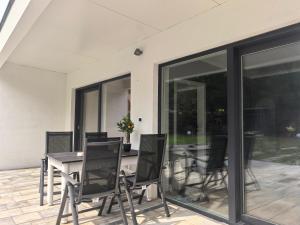 a dining room with a table and chairs on a patio at Biała Mewa in Huta +9 photos