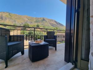 a balcony with two chairs and a table with a view at House Calamigna in Ventimiglia di Sicilia