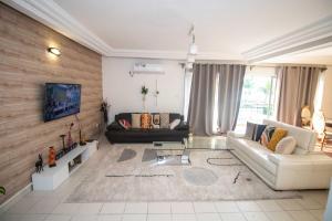 a living room with a couch and a table at A2G Apartments in Douala
