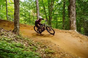 a person riding a bike on a dirt road at LE COZY - Mont Sainte-Anne in Beaupré