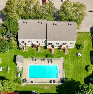 an aerial view of a house with a swimming pool at LE COZY - Mont Sainte-Anne in Beaupré
