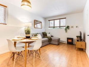 a living room with a table and a couch at LE COZY - Mont Sainte-Anne in Beaupré