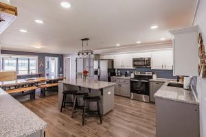 a large kitchen with white cabinets and a large island at All Seasons Resort with Lake Access in Georgetown