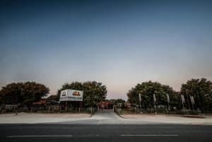 an empty road with a sign on the side of it at Mokoro Lodge in Maun