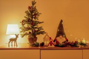 ein Tisch mit einem Weihnachtsbaum und Dekorationen darauf in der Unterkunft Spacious Studio Close to City Center l Washing Machine l Kitchen in Novi Sad + 31 Fotos