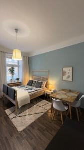 a bedroom with a bed and a table and chairs at Enjoy Wien in Vienna