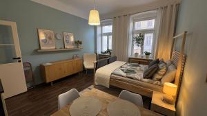 a bedroom with a bed and a dining room at Enjoy Wien in Vienna