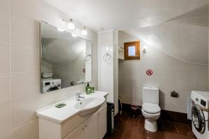 a bathroom with a sink and a toilet and a mirror at Monemvasia modern flat nearby sea in Monemvasia +52 photos