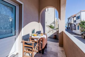 a balcony with a table and chairs on a building at Monemvasia modern flat nearby sea in Monemvasia