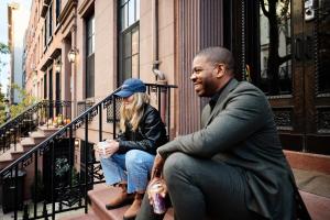 a man and a woman sitting on the steps of a building at Outsite Chelsea in New York